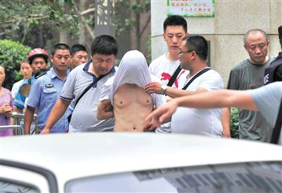 昨日，成都警方抓捕時(shí)與毒犯發(fā)生槍?xiě)?zhàn)。一名男犯罪嫌疑人被警方押出。