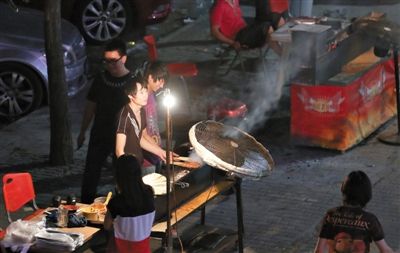 7月4日，青年路國(guó)美第一城小區(qū)附近的夜市臨街露天燒烤攤。