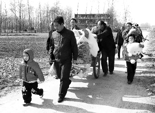 姐（左一）弟（右一護(hù)士懷中男嬰）返鄉(xiāng)，愛心捐贈(zèng)滿滿一架子車。